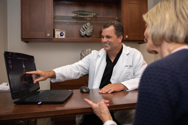 doctor clark showing an elderly dental patient her xray