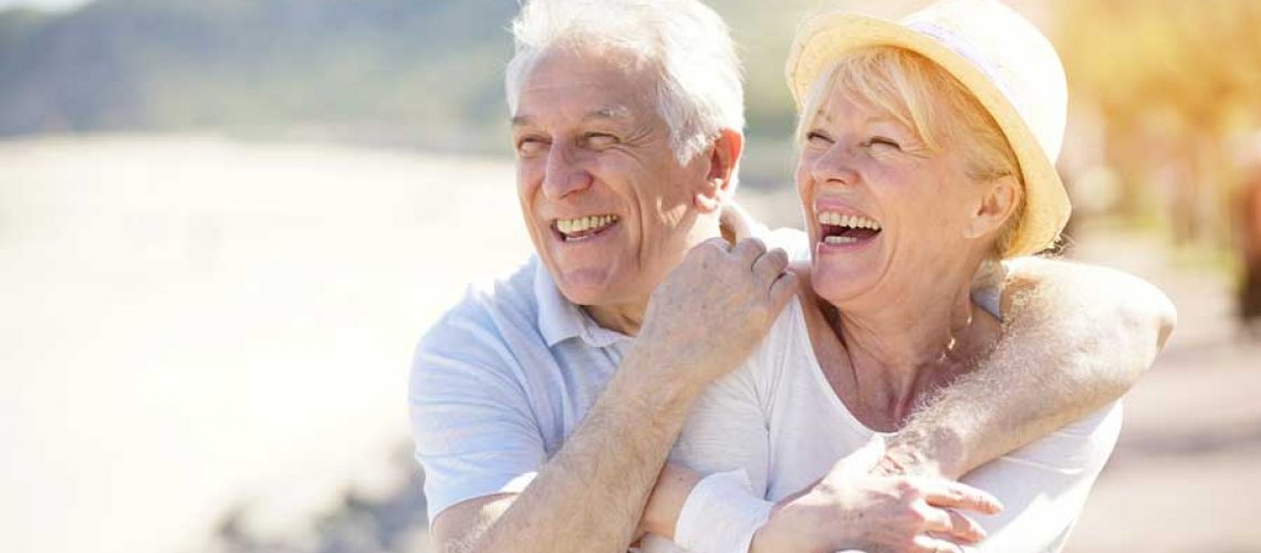 a couple smiling with their new dental implants