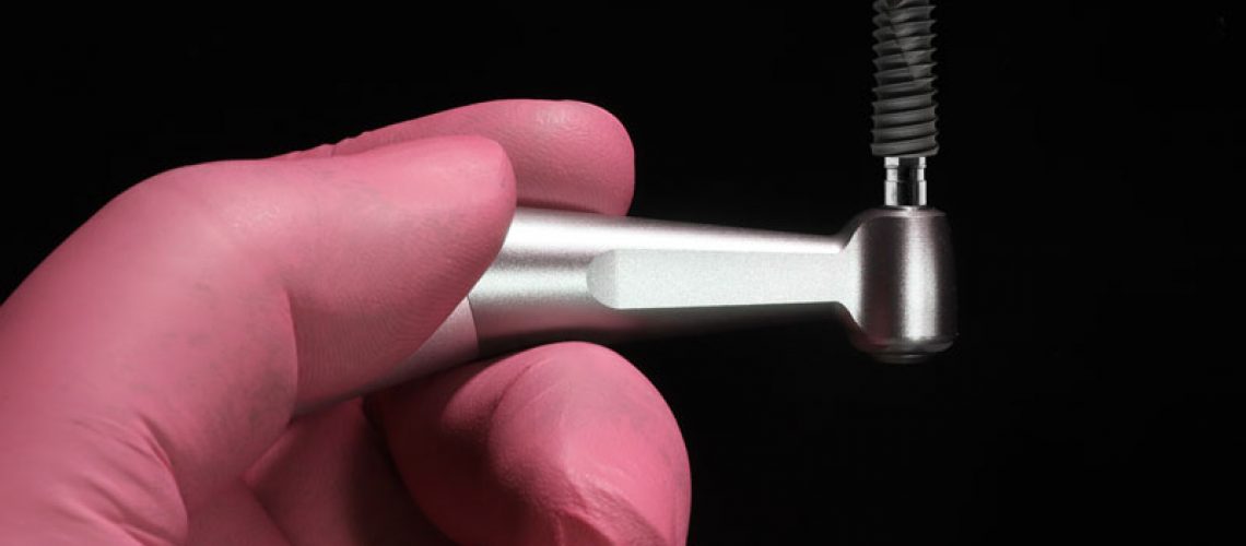 an implant being held up with a placement tool